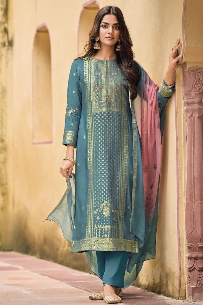 Model wearing a teal embroidered Pakistani suit with a rose dupatta